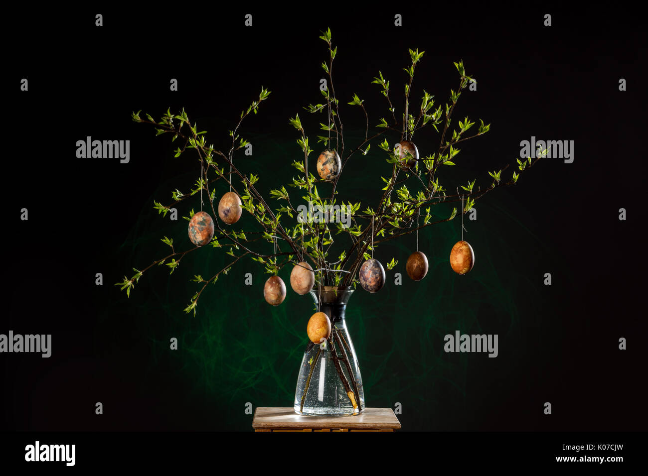Vase with tree branches and multicolored hand painted easter eggs Stock Photo
