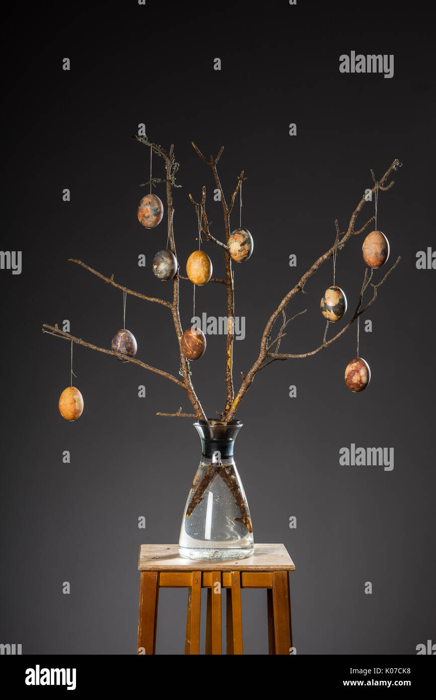 Vase with tree branches and multicolored hand painted easter eggs Stock Photo