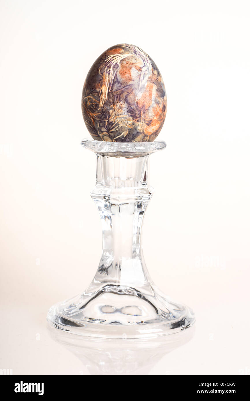 Multicolored hand painted easter egg on candlestick Stock Photo