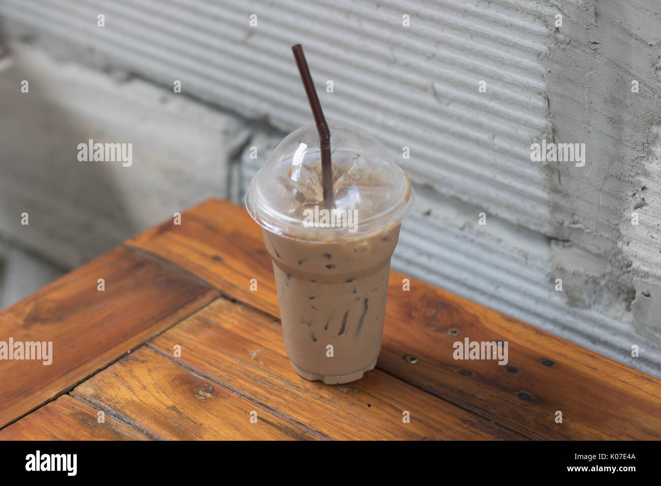 https://c8.alamy.com/comp/K07E4A/iced-coffee-in-take-away-cup-plastic-glass-on-the-wood-table-in-cafe-K07E4A.jpg