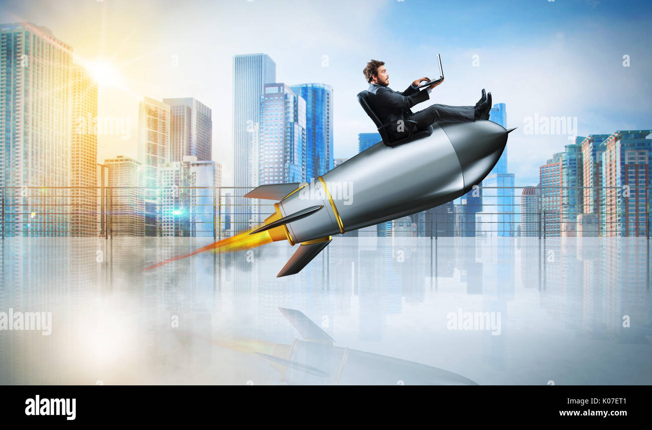 Fast internet concept with a businessman with laptop over a rocket Stock Photo