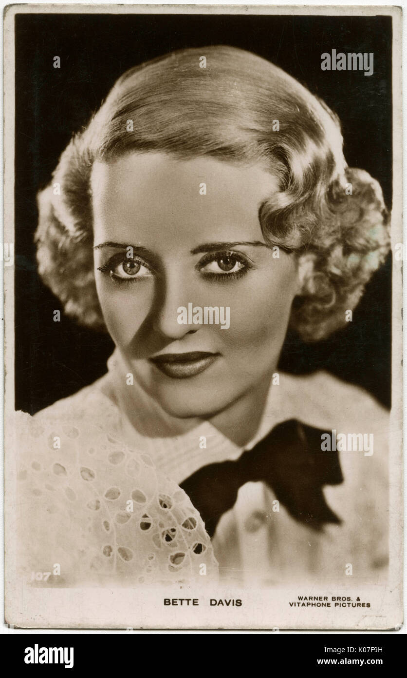 Bette Davis (1908 - 1989), American film actress, wearing a white top with a black bow      Date: Stock Photo