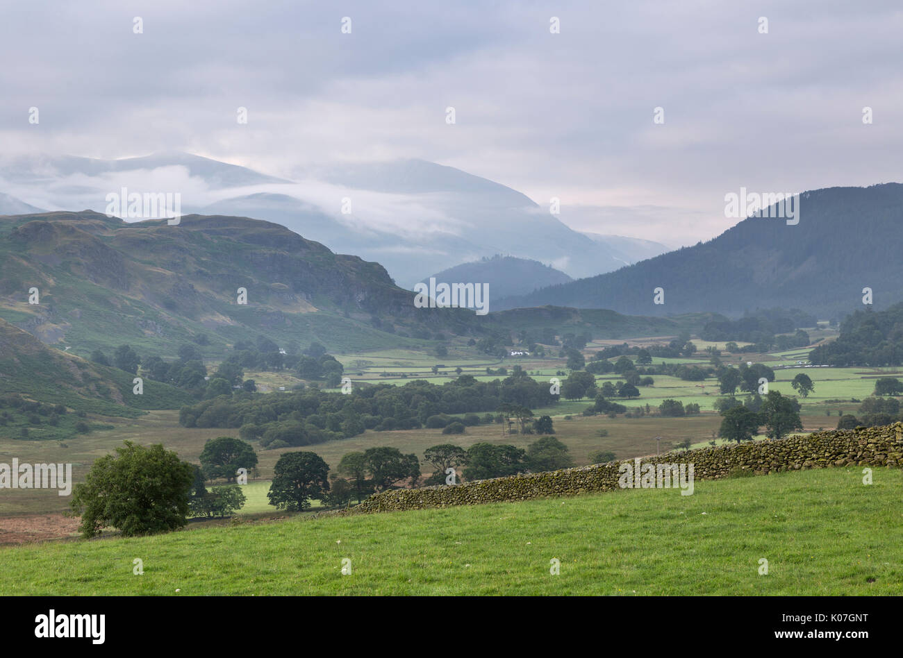 Looking SE from Castle Rigg stone circle, with the valley of the Naddle Beck in the foreground, High Rigg, and Helvellyn - shrouded in clouds - beyond Stock Photo