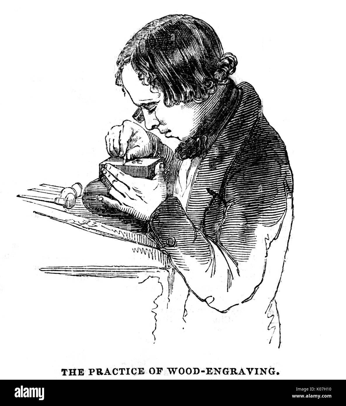 Wood engraver at work  on a block.        Date: circa 1850 Stock Photo
