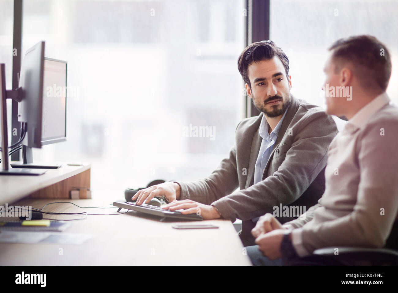 Picture of two young businessmen having discussion Stock Photo