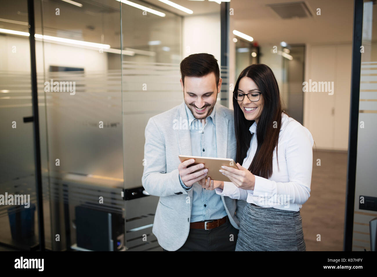 Portrait of attractive business partners using tablet Stock Photo