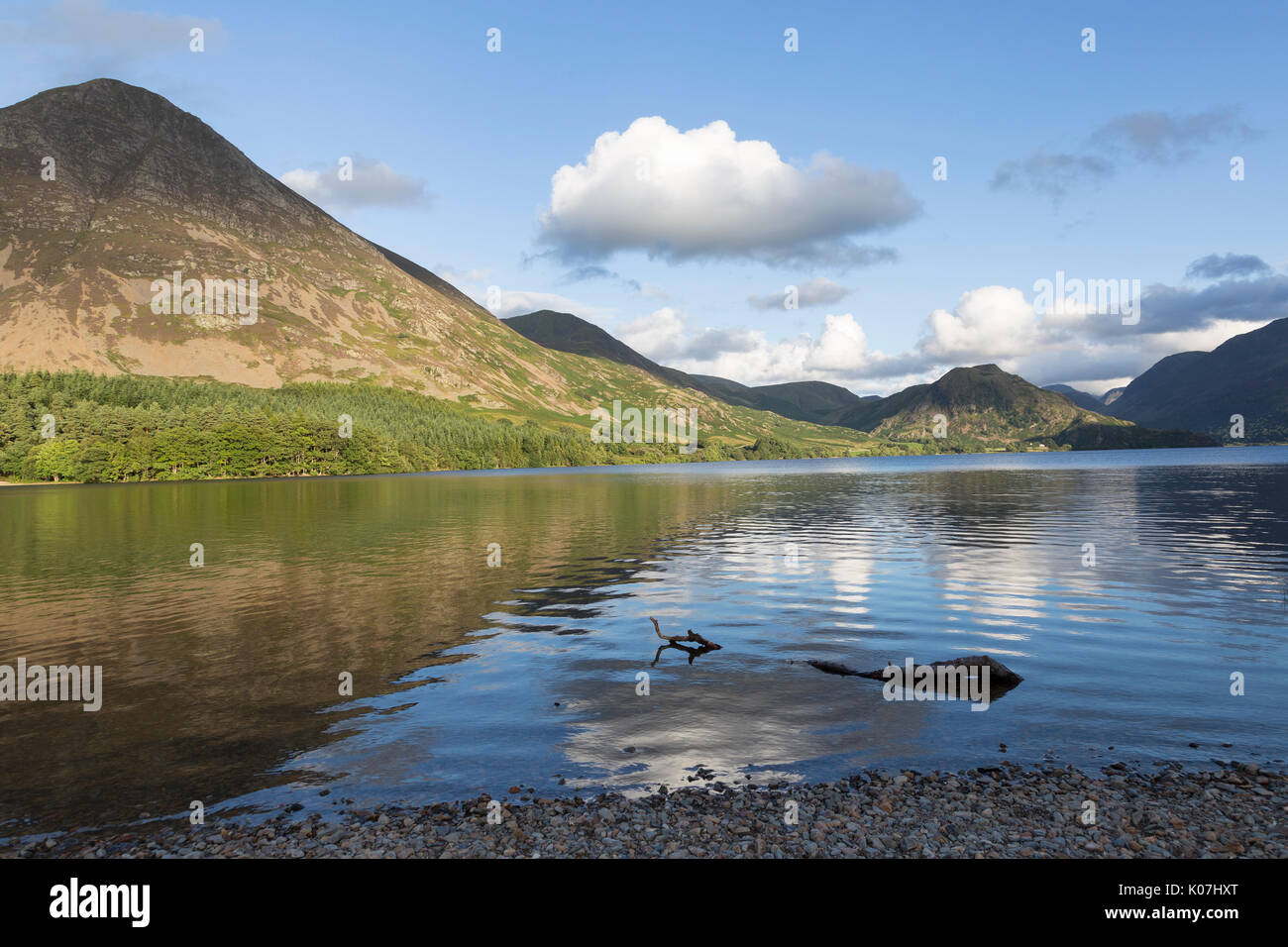 A view of Grasmoor (the mountain on the left of the picture), seen here from the northern shore of Crummock Water, in the Lake District, Cumbria, UK Stock Photo