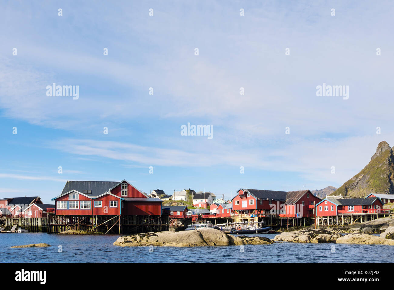 Red wooden fishermen's huts and buildings on stilts by water in fishing village of Å, Moskenes, Moskenesøya Island, Lofoten Islands, Nordland, Norway Stock Photo