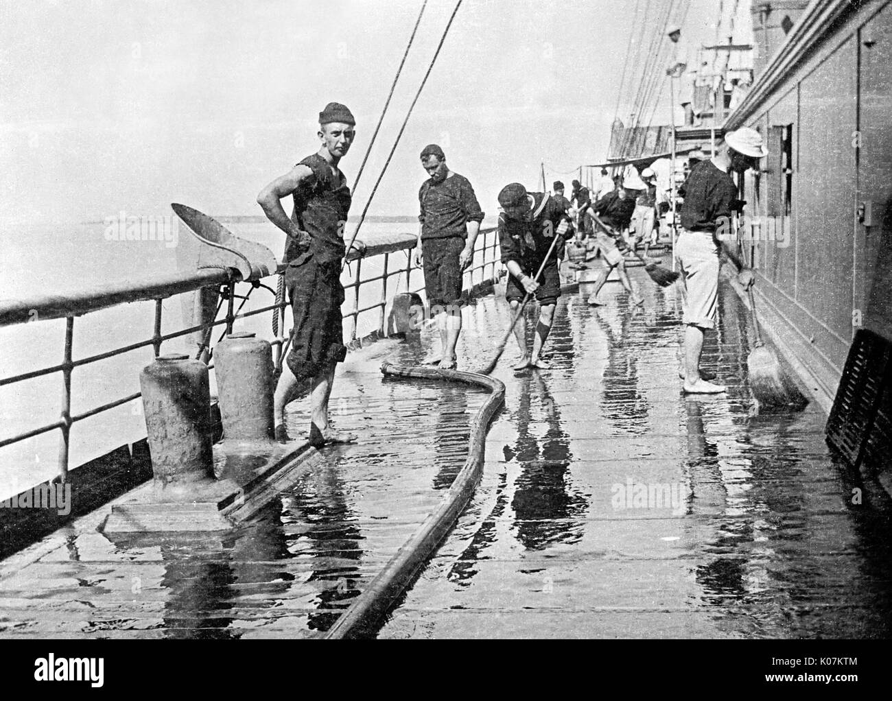 Sailor washing down decks on the U.S.S. Yankee Stock Photo