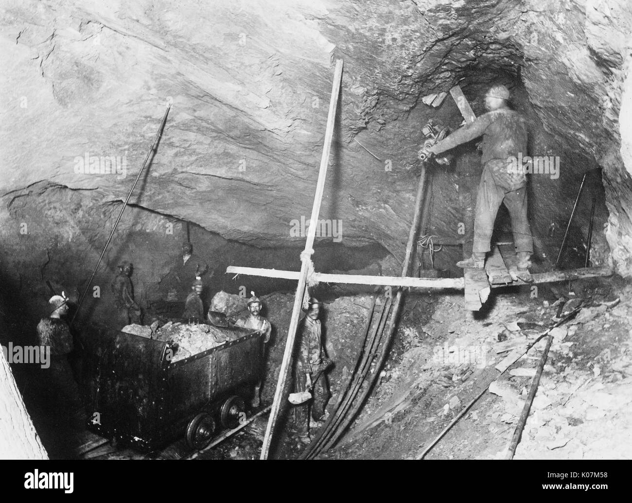 Miners loading a mine car in a coal mine in America Date circa 1920