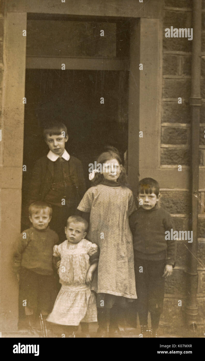 Five children on a doorstep Stock Photo