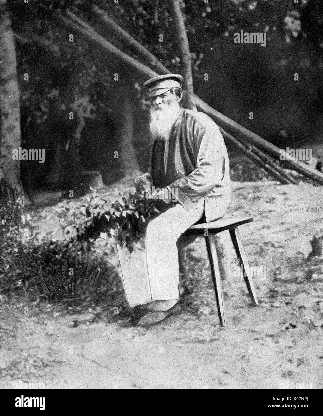 An old peasant man and beekeeper who survived the First World War. It is claimed that the nearby German shelling made his bees angry, so that they started attacking him, but he dug himself a trench to protect himself from them.       Date: circa 1918 Stock Photo