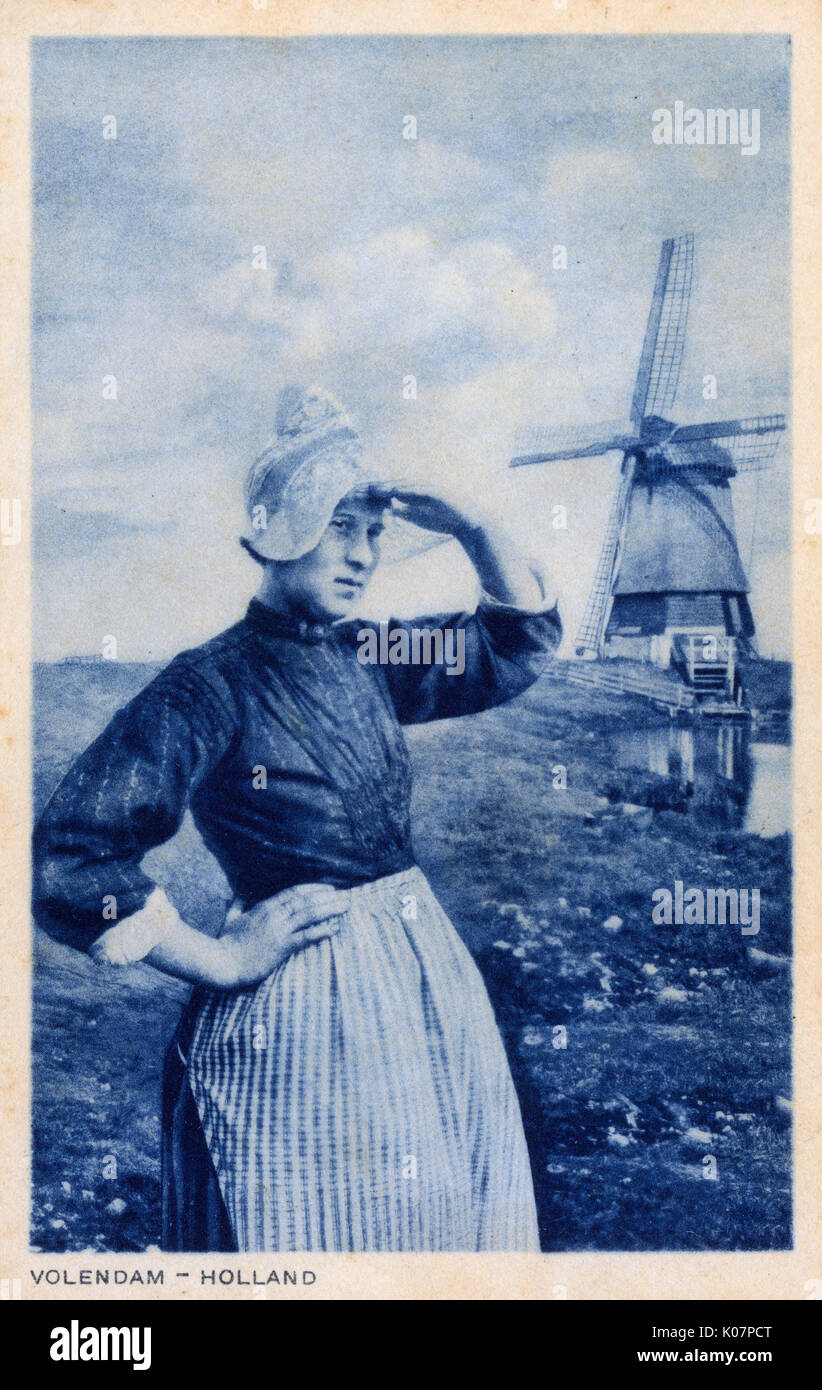 Woman and windmill, Volendam, Netherlands Stock Photo