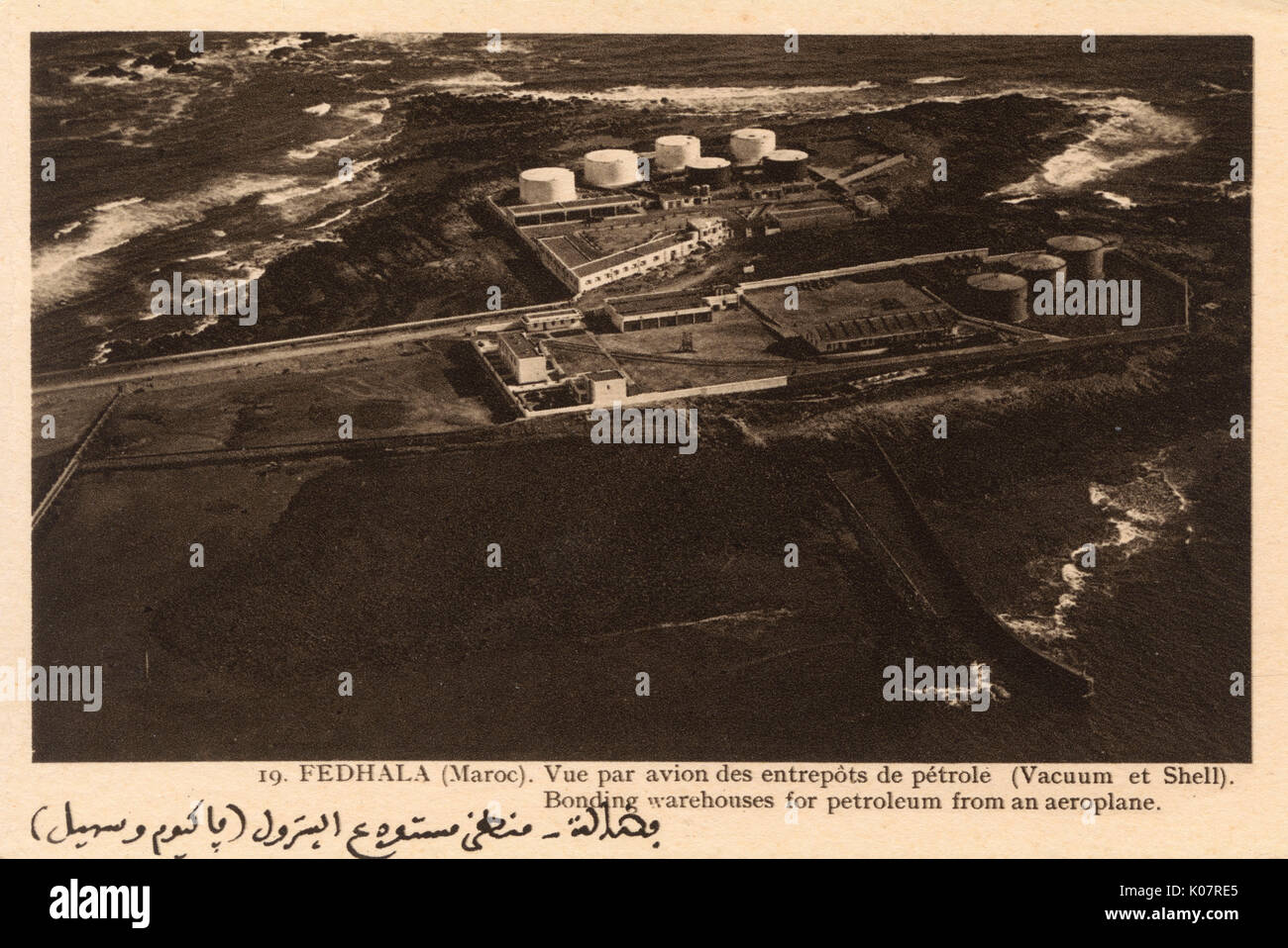 Aerial view of Fedala (Fedhala, now Mohammedia), Morocco, centre of the Moroccan oil industry, showing Vacuum and Shell bonding warehouses and petroleum storage tanks.     Date: circa 1930 Stock Photo