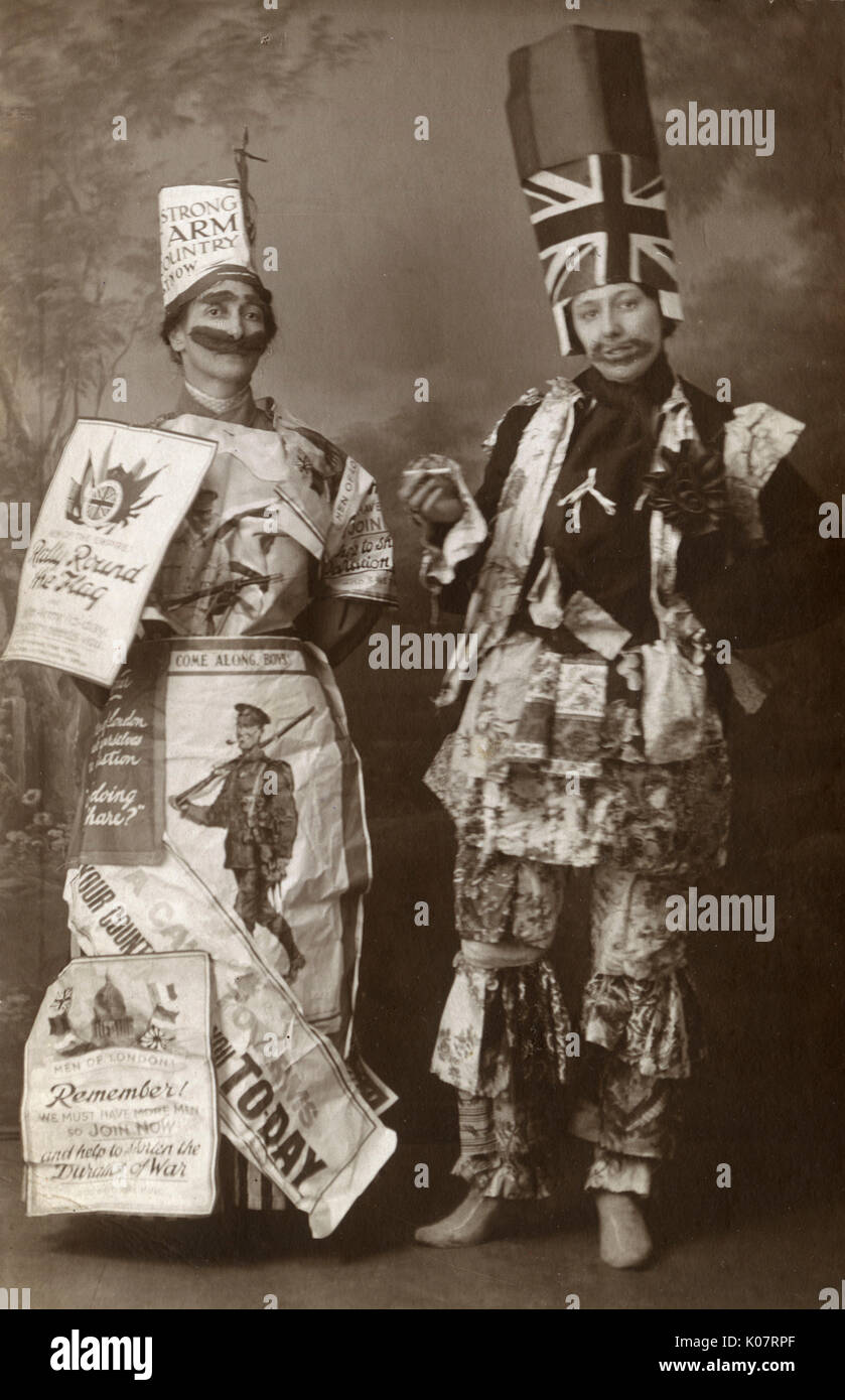 WW1 era - British Home front - A remarkable set of 3 postcards featuring three women, two of whom are dressed in patriotic fancy dress. In this card the lady on the left is festooned in wartime recruitment posters and has a fabulous fake Lord Kitchener moustache (and eyebrows). The lady on the right has gone for a painted-on beard (?), Union flag (tall) hat, rosette, floral fabric adornments and (very weirdly) a shoe insole hanging around her neck, Sadly the exact symbolism of this gesture is lost to time...     Date: circa 1916 Stock Photo