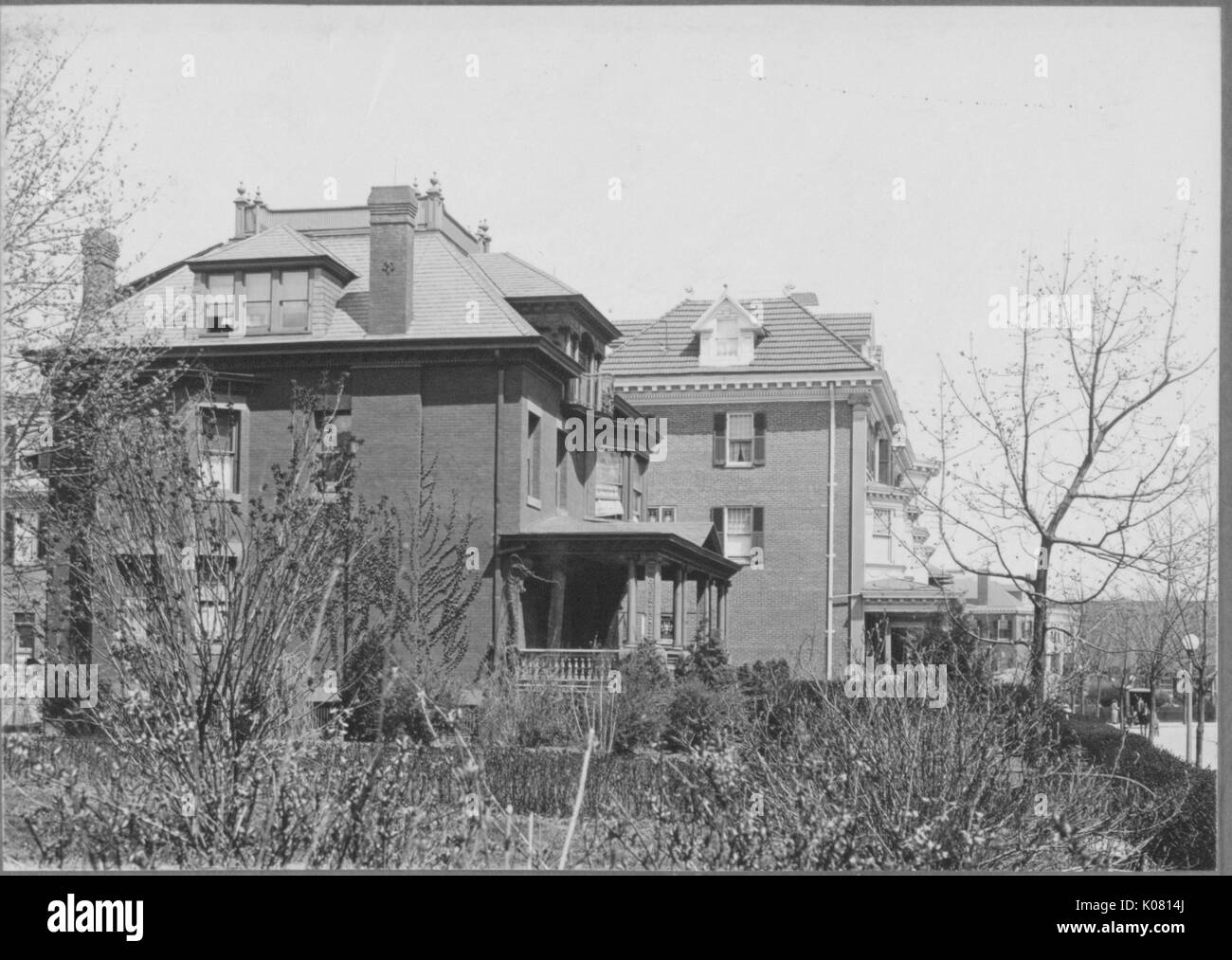 Side view of two-story brick homes near Roland Park and Guilford, United States, 1910. This image is from a series documenting the construction and sale of homes in the Roland Park/Guilford neighborhood of Baltimore, a streetcar suburb and one of the first planned communities in the United States. Stock Photo