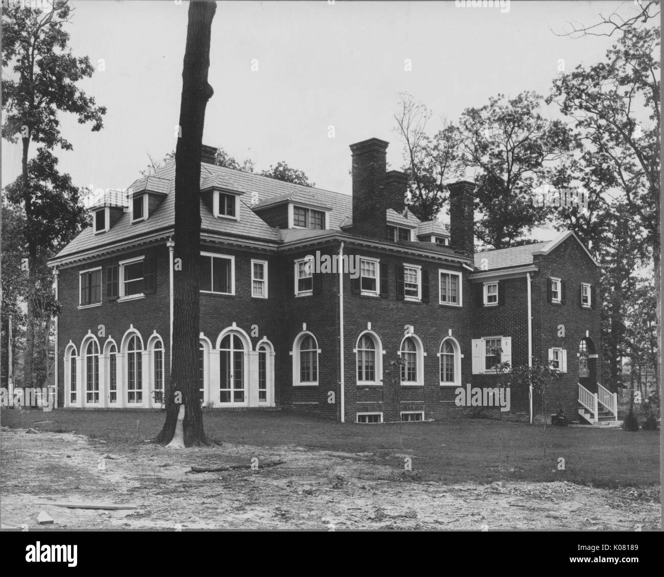 Photograph of a large threestory Roland Park home in Baltimore, made