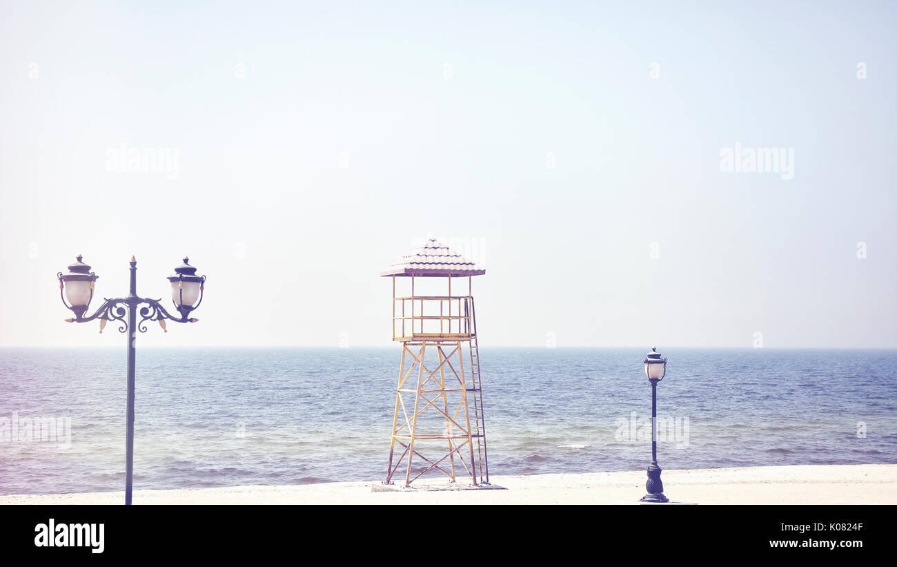 Retro old film stylized picture of a lifeguard tower on an empty beach. Stock Photo