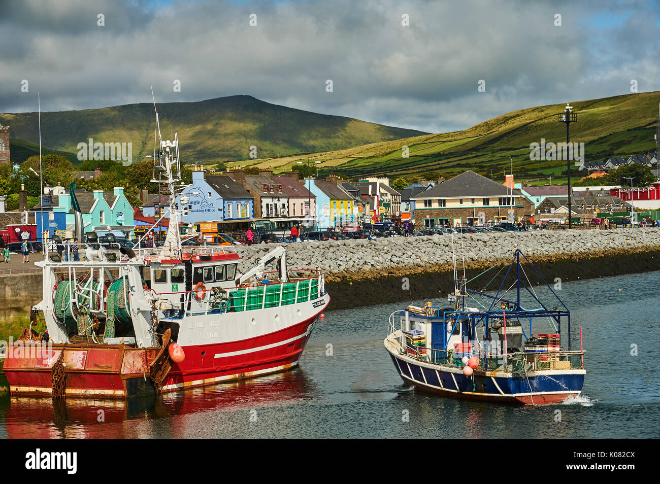 Dingle, County Kerry in the Republic of Ireland and a collection of fishing boats are moored in the small working harbour. Stock Photo