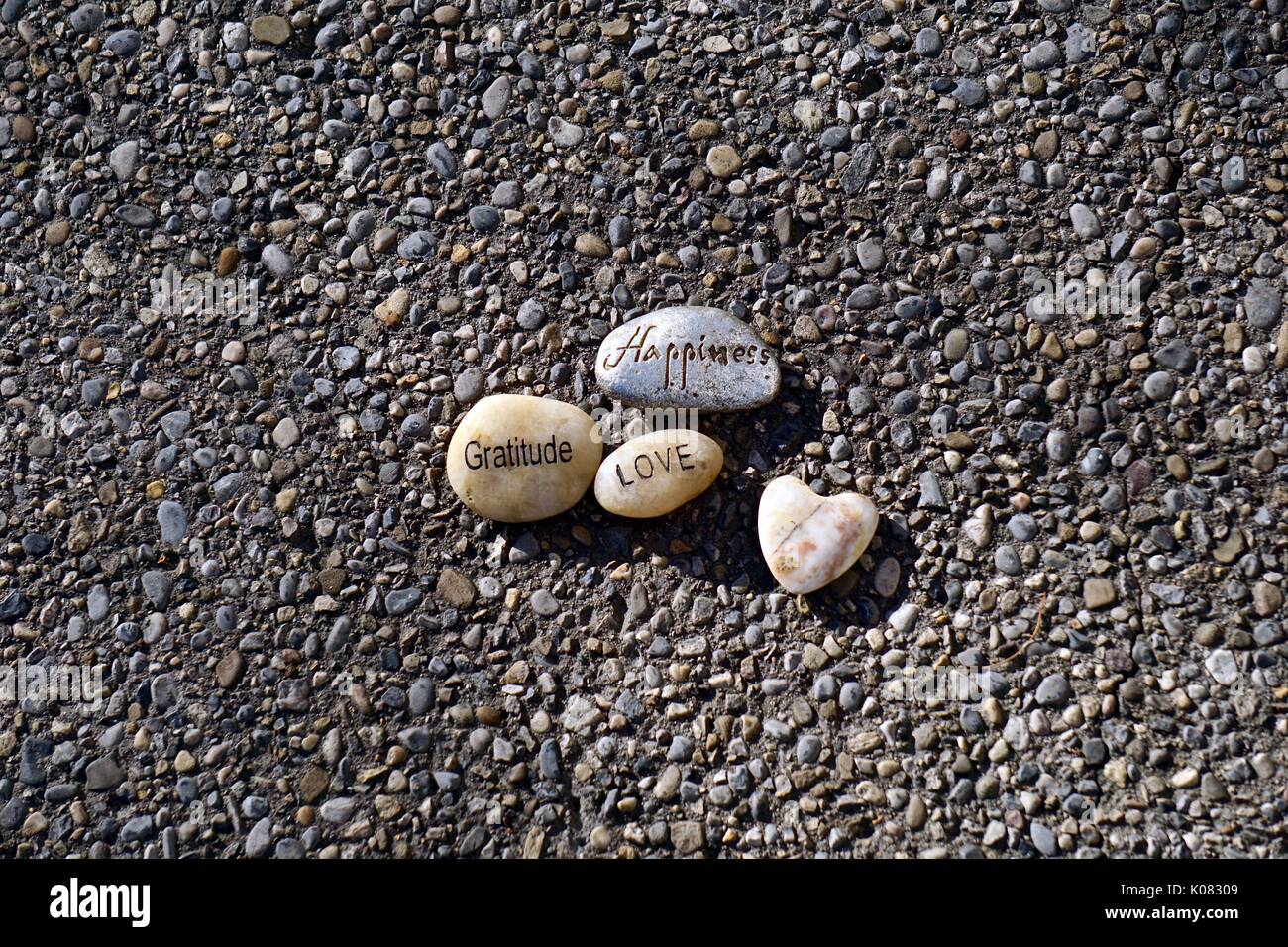 Words of Feeling printed on Rocks on pebbled surface Stock Photo