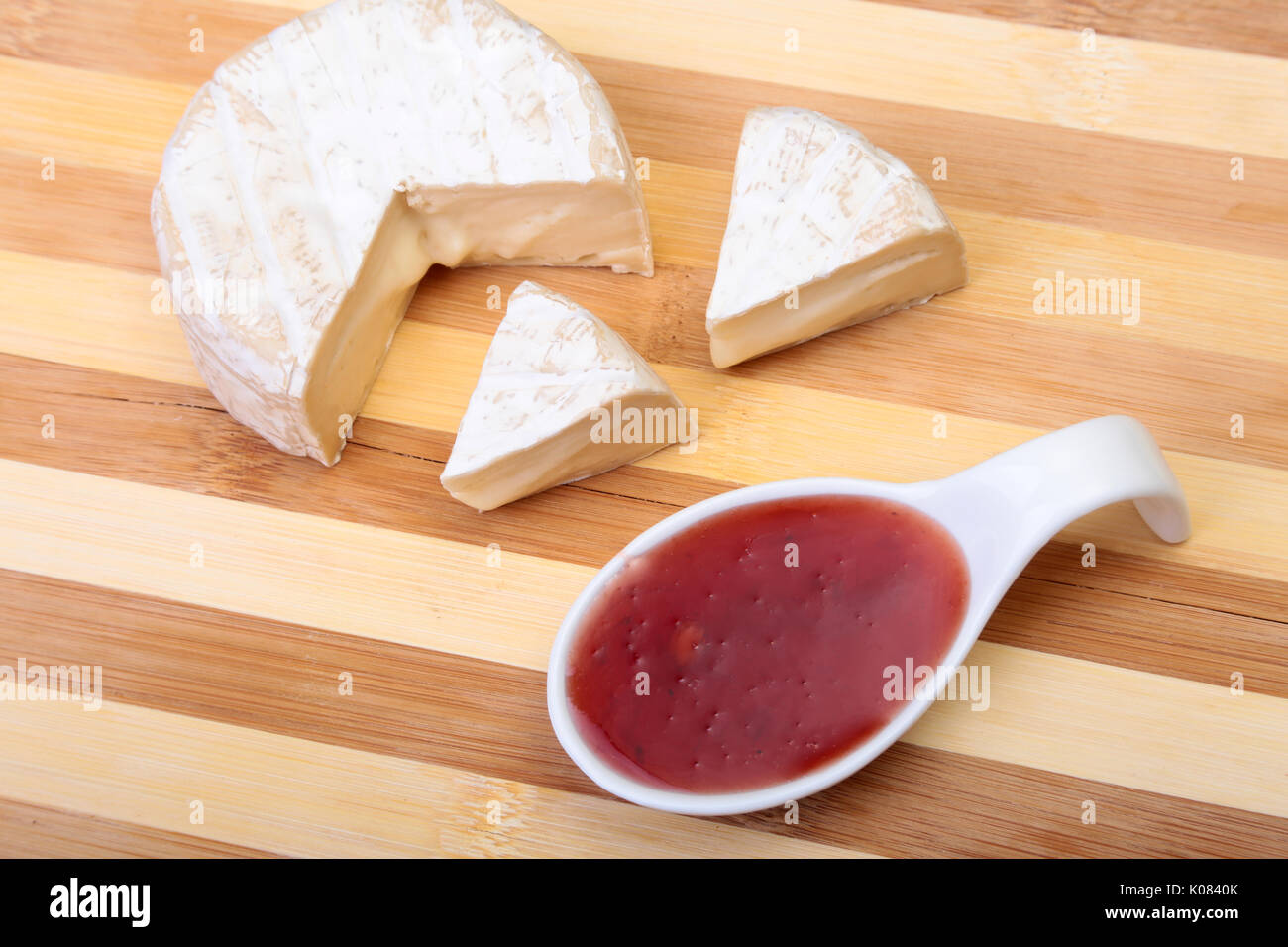 Cheese with white mold. Camembert or brie type with Cranberry sauce.. Healthy breakfast. Stock Photo