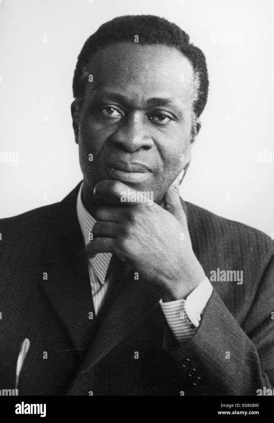 Head shot of Dr Thomas Adeoye Lambo, Nigerian scholar, administrator and psychiatrist, with a neutral expression, resting his head on his left arm, wearing a suit jacket, dress shirt, tie, and cuff links, 1973. Stock Photo