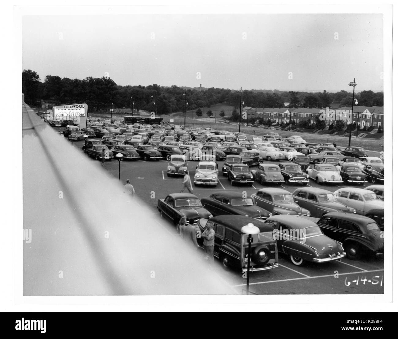 View of a packed parking lot from the roof of the Northwood Shopping Center, across the street from the center and parking lot are brick row homes, Baltimore, Maryland, 1951. Stock Photo