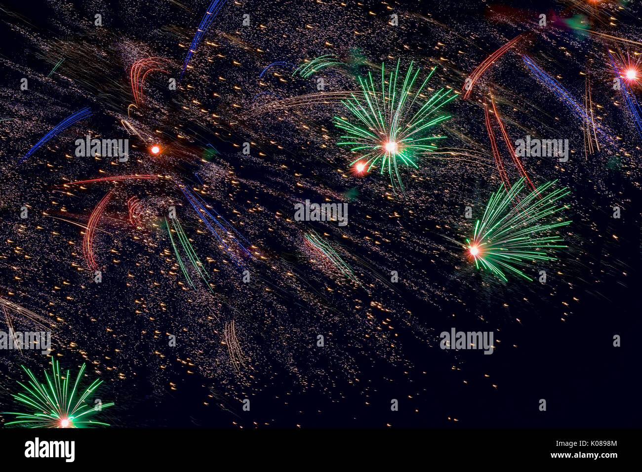 Holiday Fireworks with sparks on black sky as stars, universe, comets Stock Photo