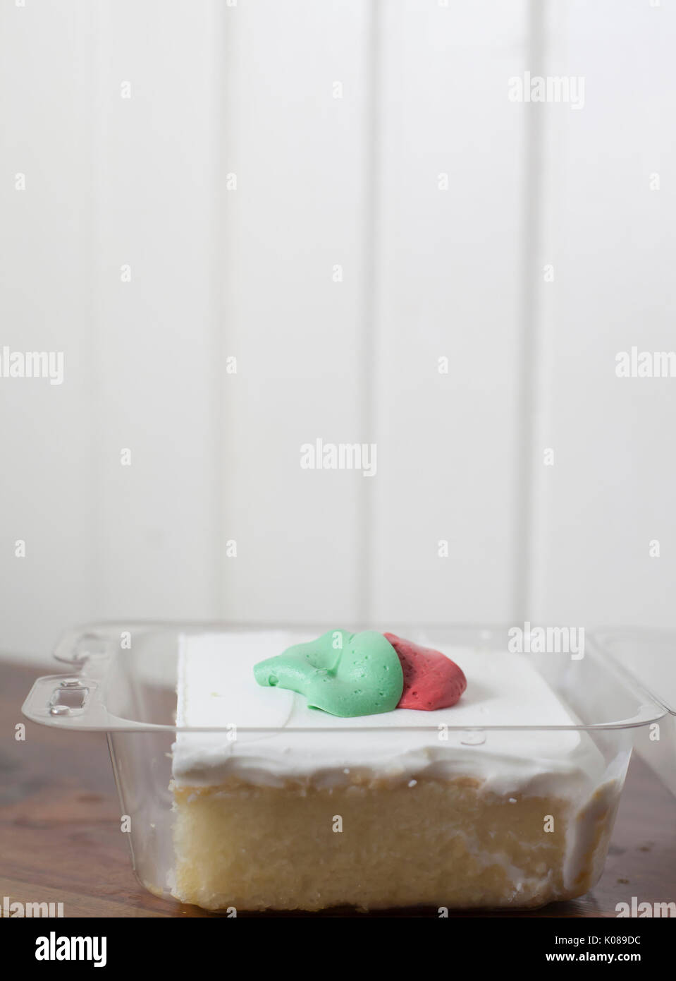 White cake with buttercream icing in a carryout container Stock Photo