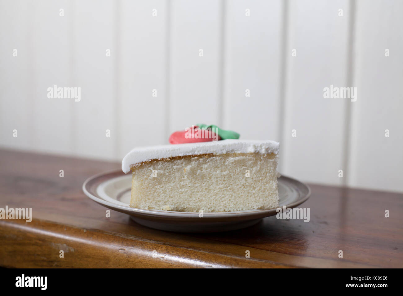 Single slice of white cake with buttercream icing Stock Photo