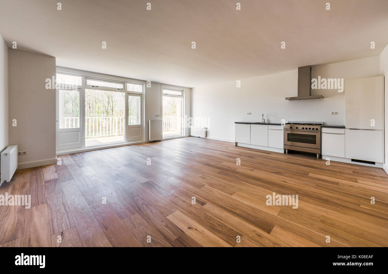 Empty Living Room with Kitchen and Open Doors to Balcony Stock Photo