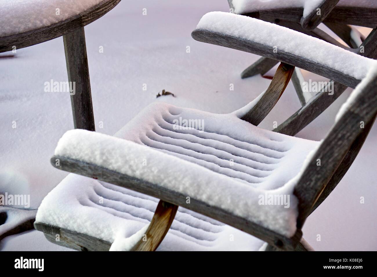 close up of Snow covered outdoor furniture Stock Photo