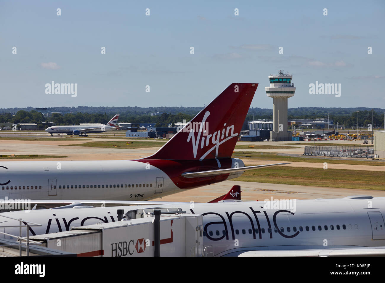 Air traffic control tower and Virgin Atlantic planes at  Gatwick Airport's North Terminal Stock Photo