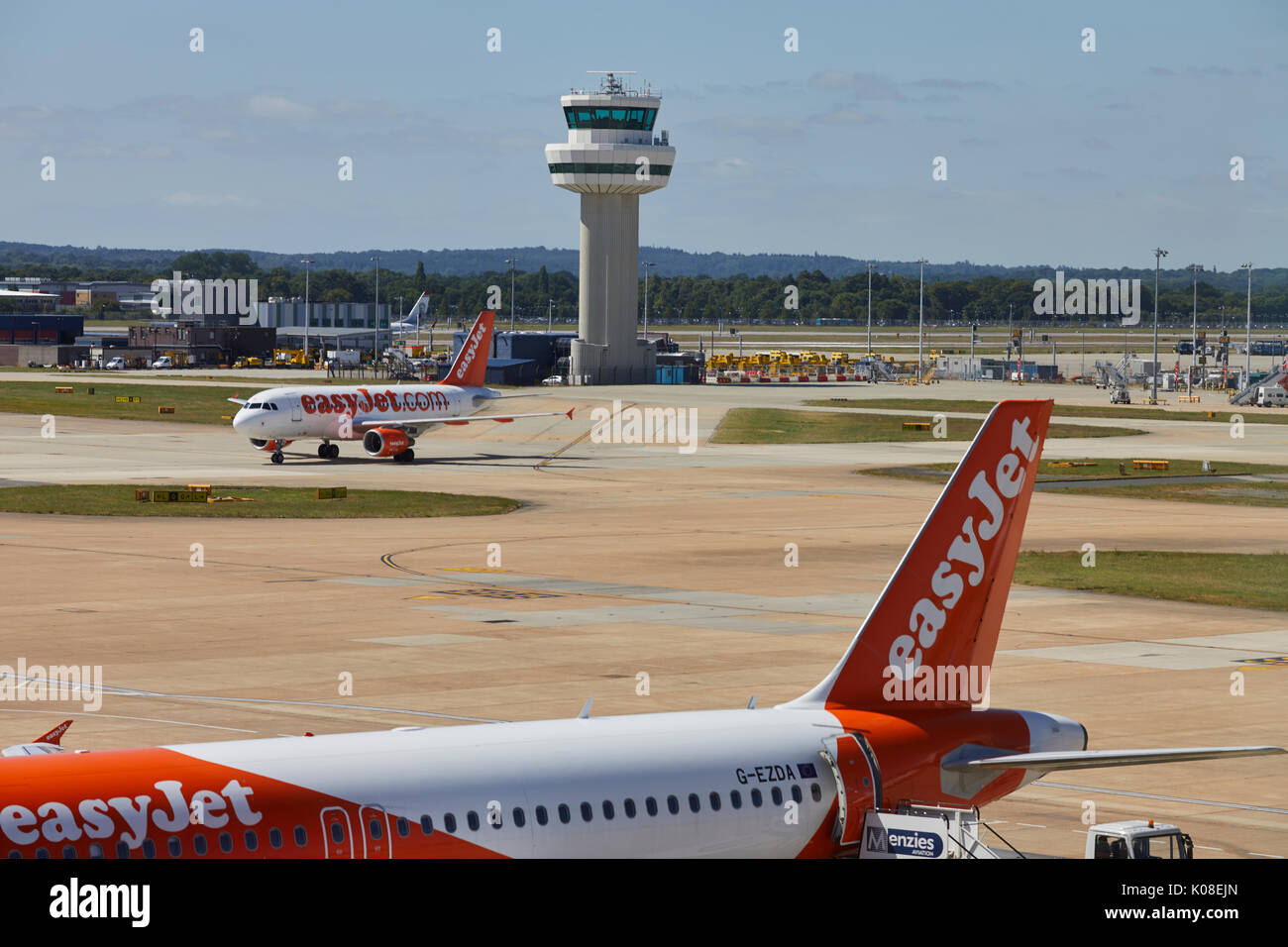Air traffic control tower and low-cost carrier EasyJet at  Gatwick Airport's North Terminal Stock Photo