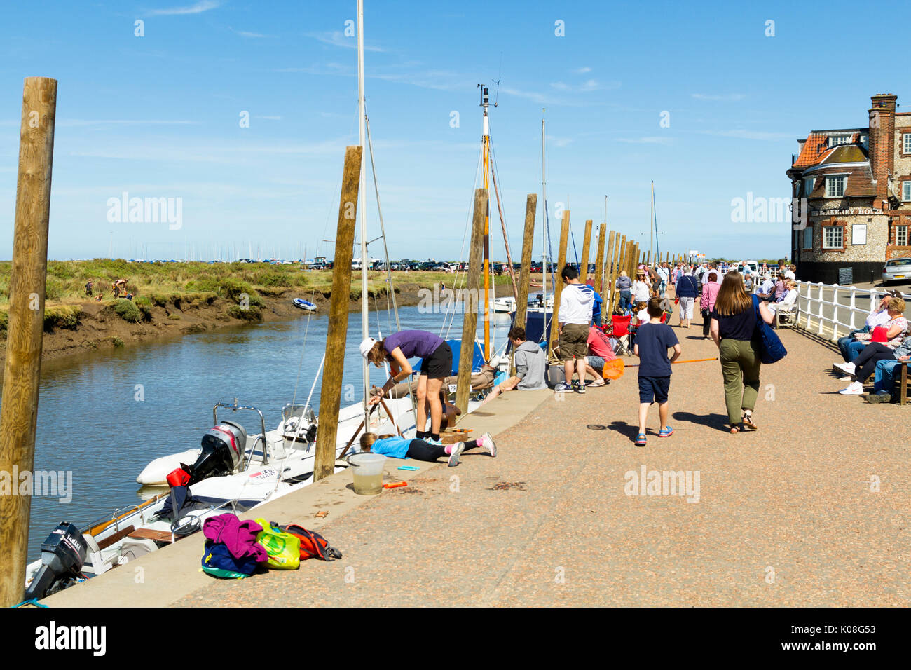 People crabbing in Blakeney harbour / Quay Norfolk Stock Photo