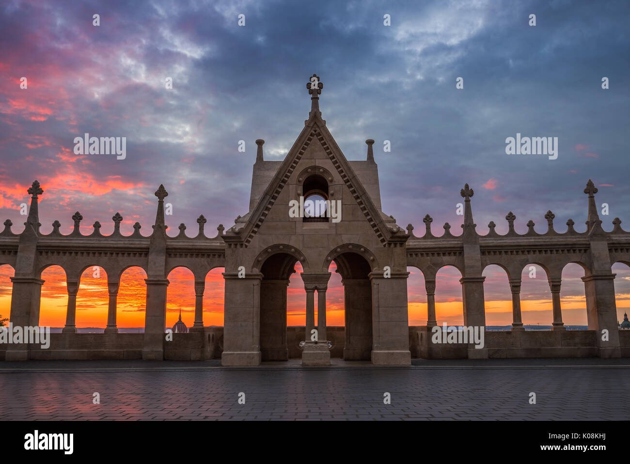 Budapest, Hungary - The Hungarian Parliament through the Fisherman's Bastion's arch windows at sunrise with beautiful sky and clouds Stock Photo