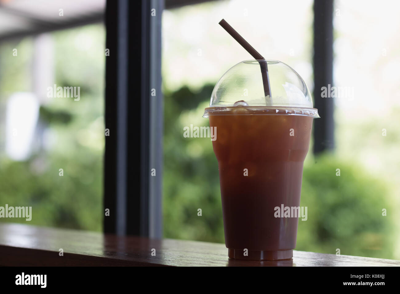 Iced Americano coffee in take away cup (plastic glass) on the wood ...