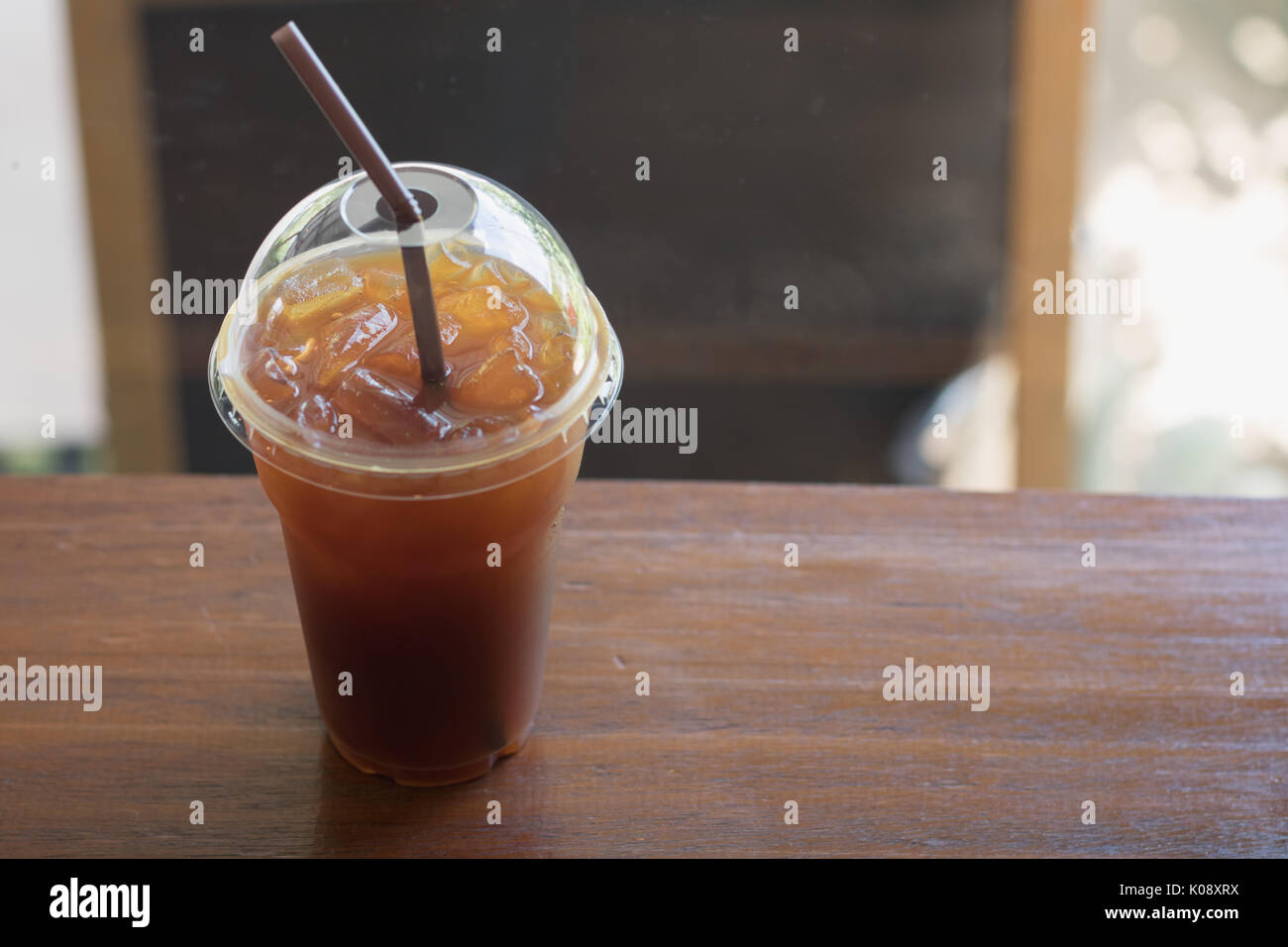 Iced Americano coffee in take away cup (plastic glass) on the wood ...