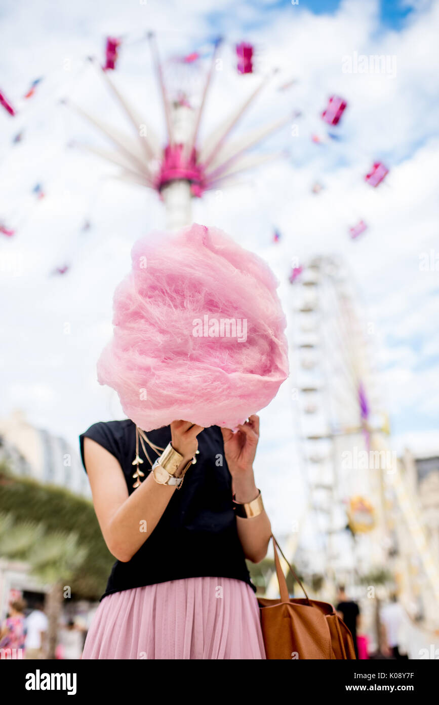Woman with cotton candy at the amusement park Stock Photo - Alamy