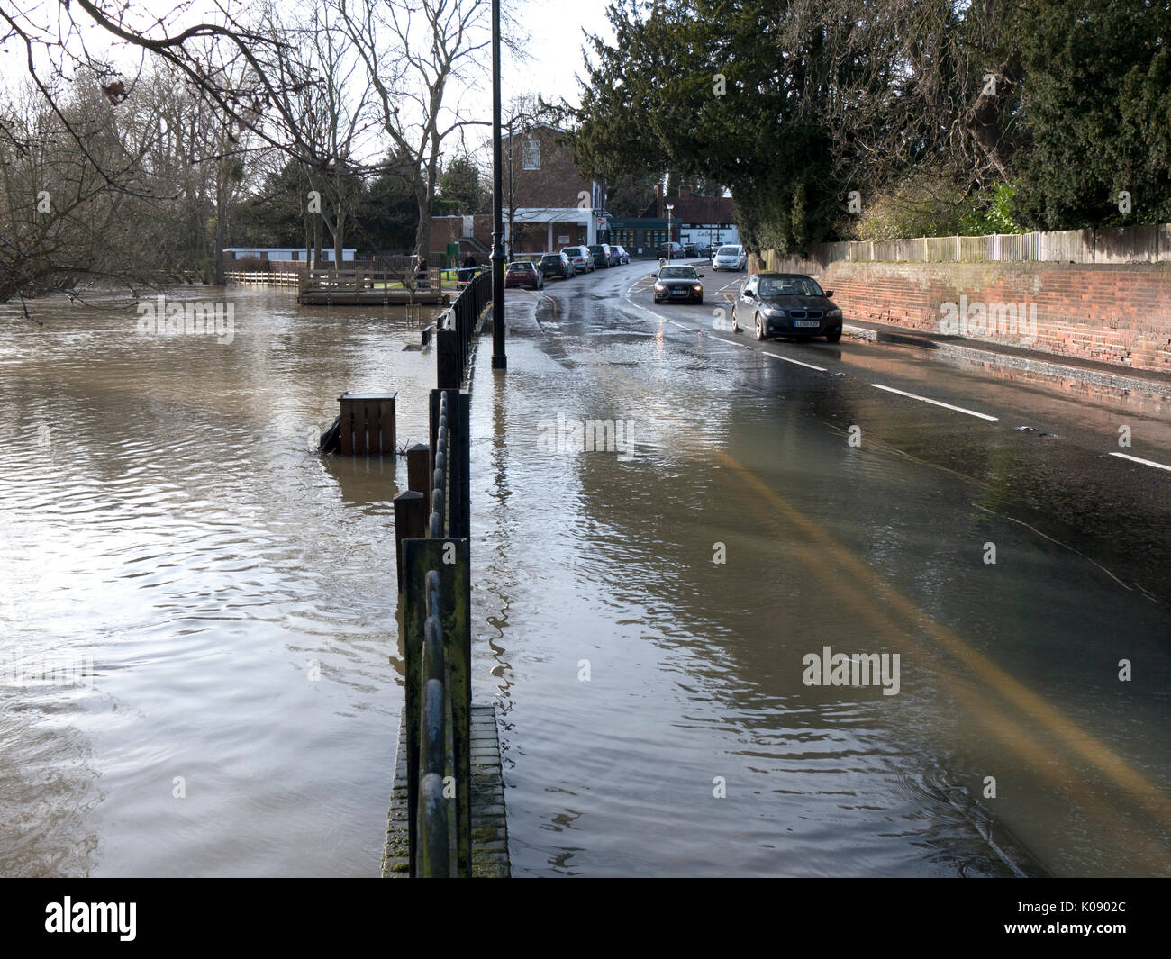 UK, Surrey, Cobham, flood water on road splash Stock Photo 155090948