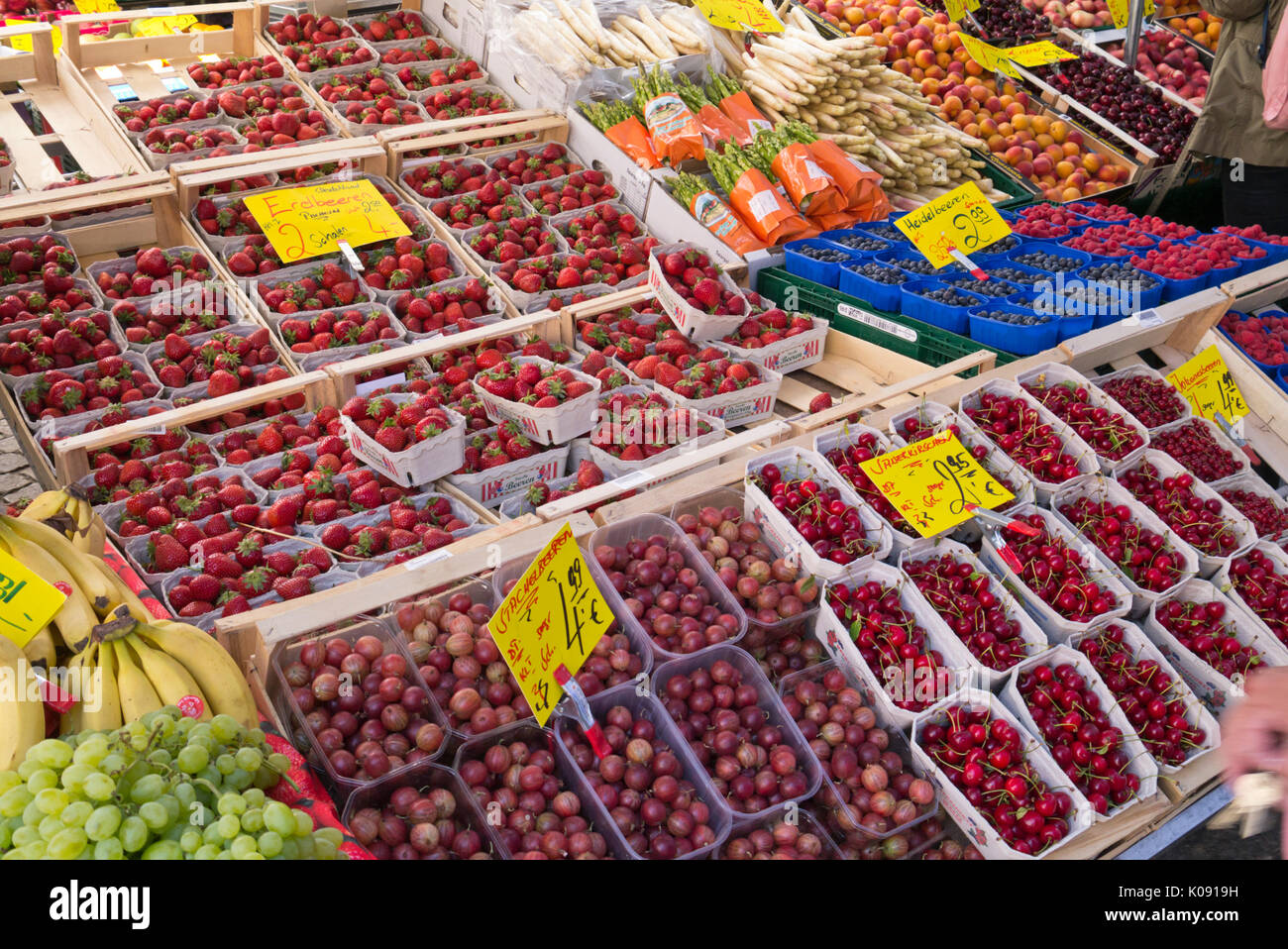 Garden strawberry (Fragaria x ananassa), gooseberries (Ribes uva-crispa) and sour cherrys (Prunus cerasus) Stock Photo