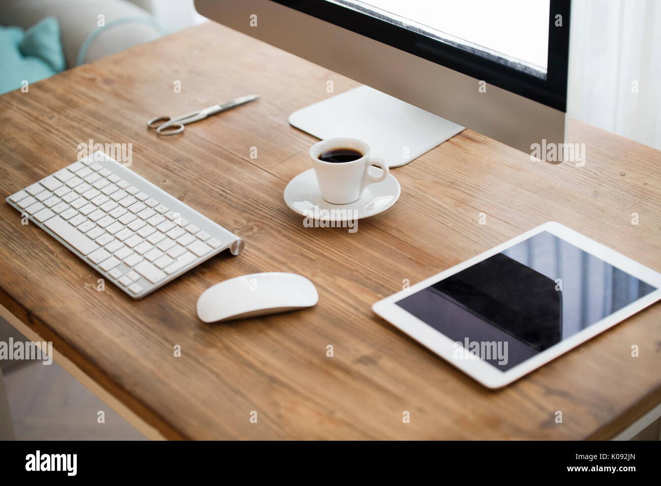 Picture of computer, scissors and camera on working desk Stock Photo