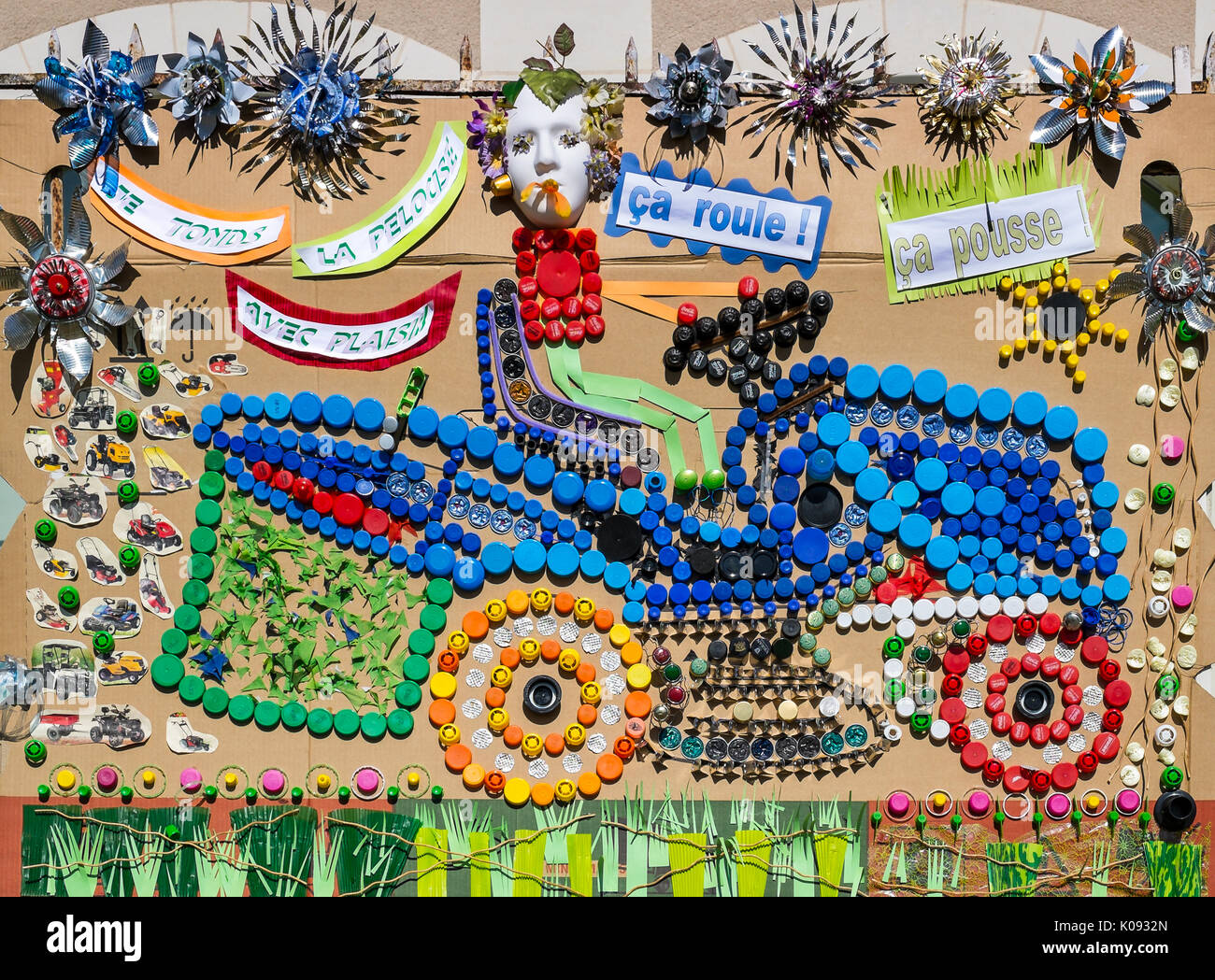 Motor mower picture / collage made by schoolchildren from recycled bottle tops, France. Stock Photo