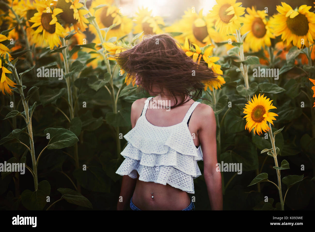 Girl in field of sunflowers Stock Photo - Alamy