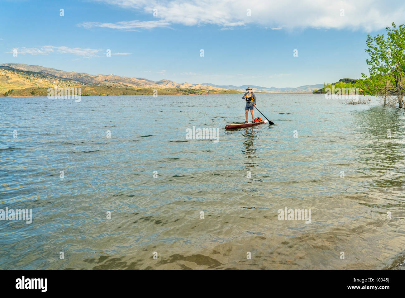 paddling stand up paddleboard on mountain lake in COlorado, summer