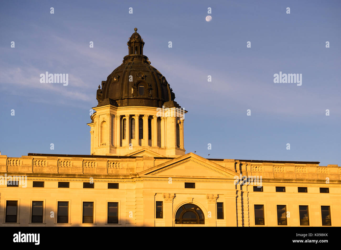 The moon shines behind the capitol dome in Pierre, SD Stock Photo