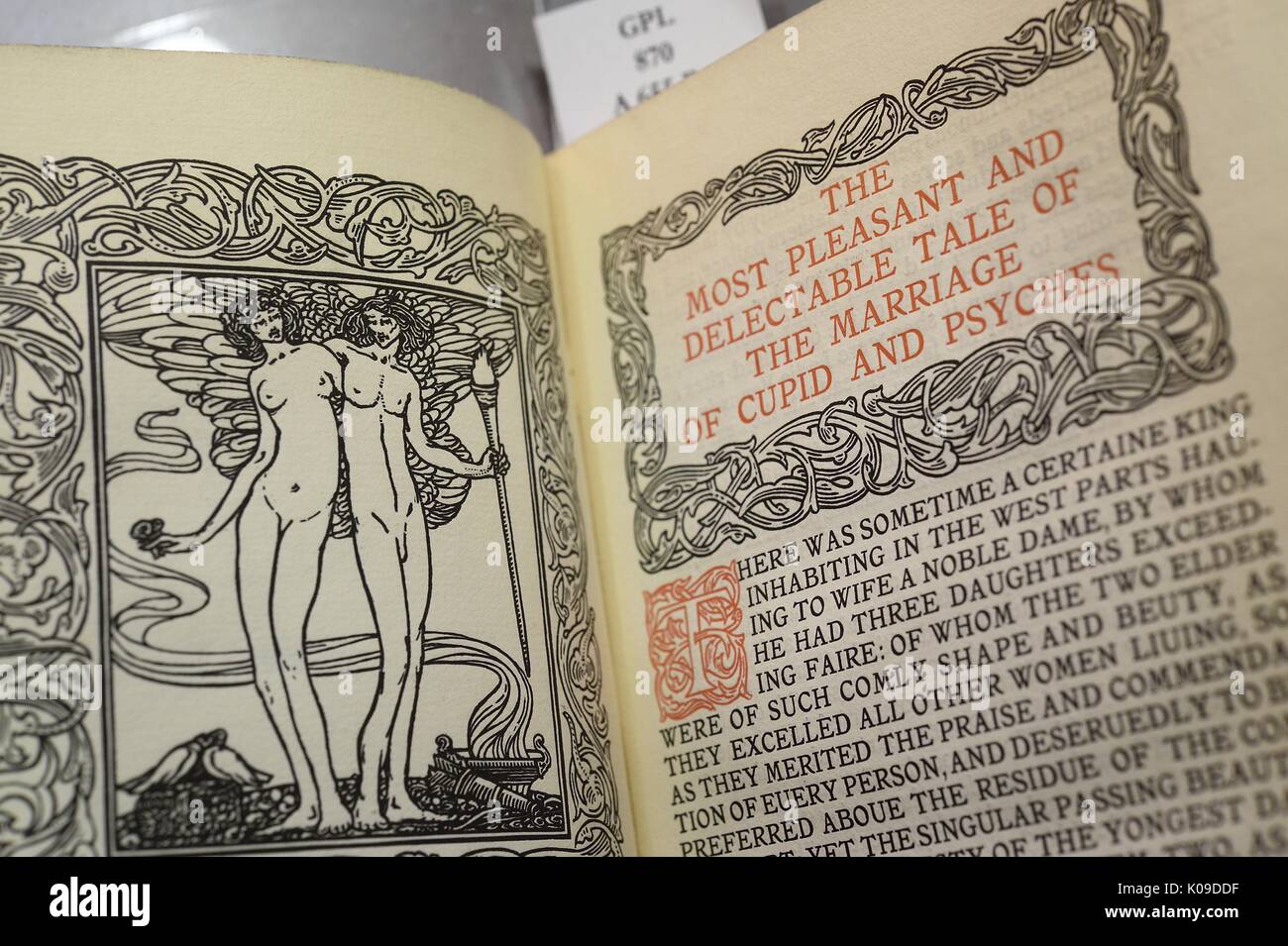 Photo of an open book, on one side is an illustration of Cupid and Psyches and on the other page is the title 'The Most Pleasant and Delectable Tale of The Marriage of Cupid and Psyches' and the beginning of the story, February 11, 2016. Stock Photo