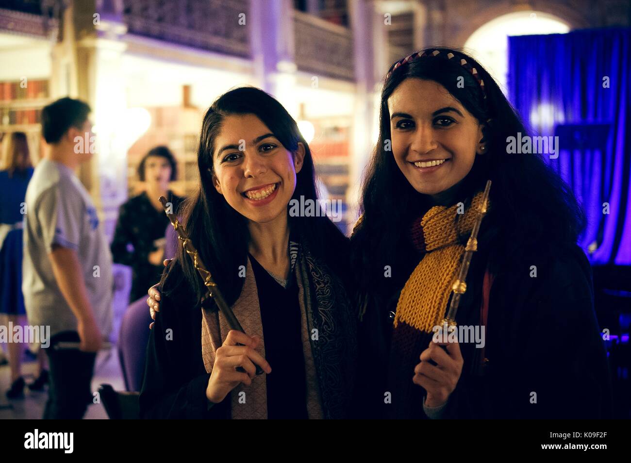 Two smiling female students holding up wands, dressed as characters from the Harry Potter world; Halloween at Peabody, October 31, 2015. Courtesy Eric Chen. Stock Photo