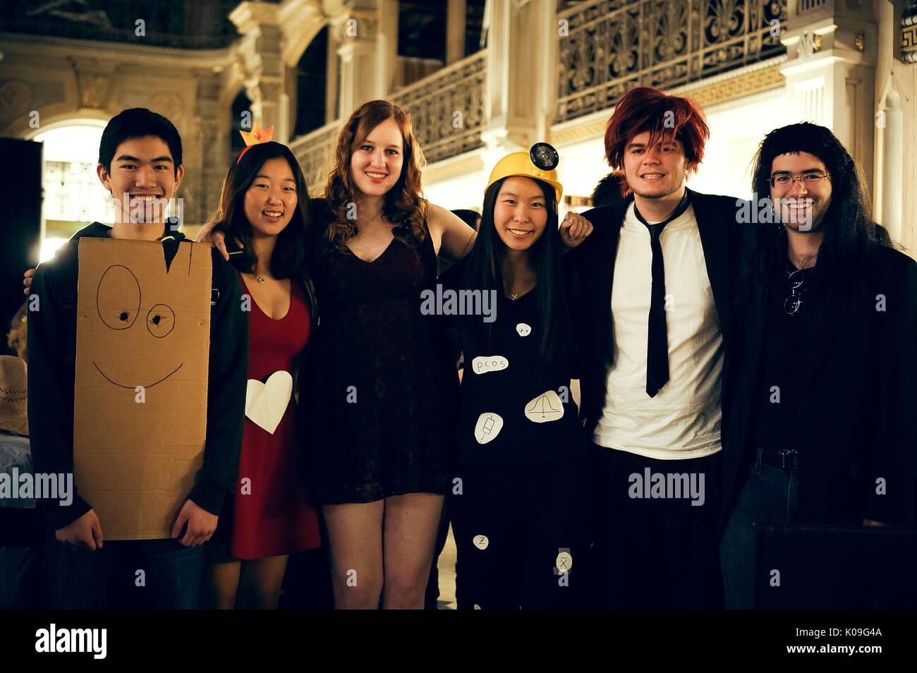 A group of college students pose for a picture, all of the students are in various costumes, Halloween at Johns Hopkins University's George Peabody Library, 2015. Courtesy Eric Chen. Stock Photo