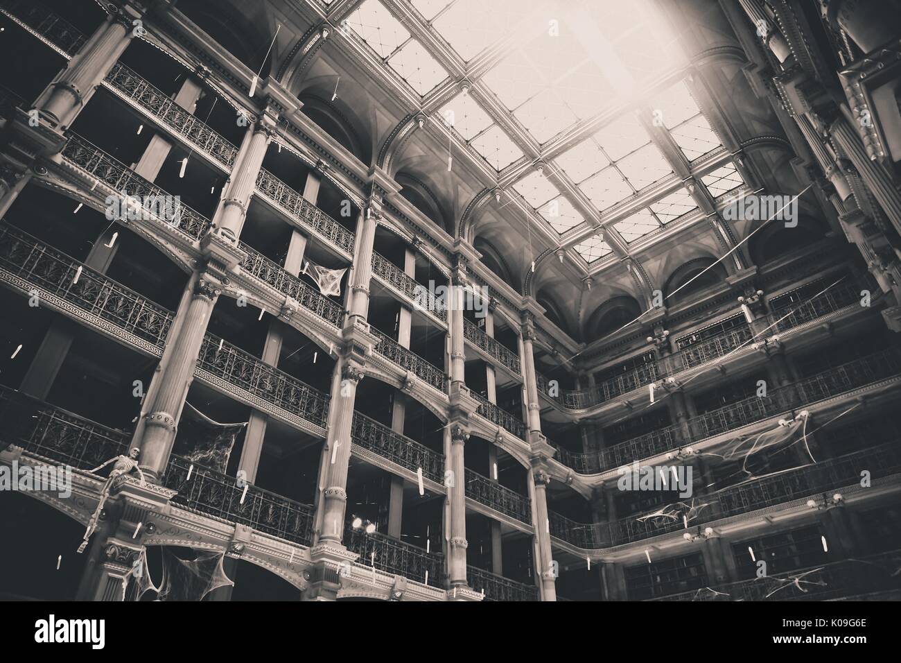Black and white low angle view looking upward at the many floors and ceiling of the George Peabody Library at the Johns Hopkins University, 2015. Courtesy Eric Chen. Stock Photo